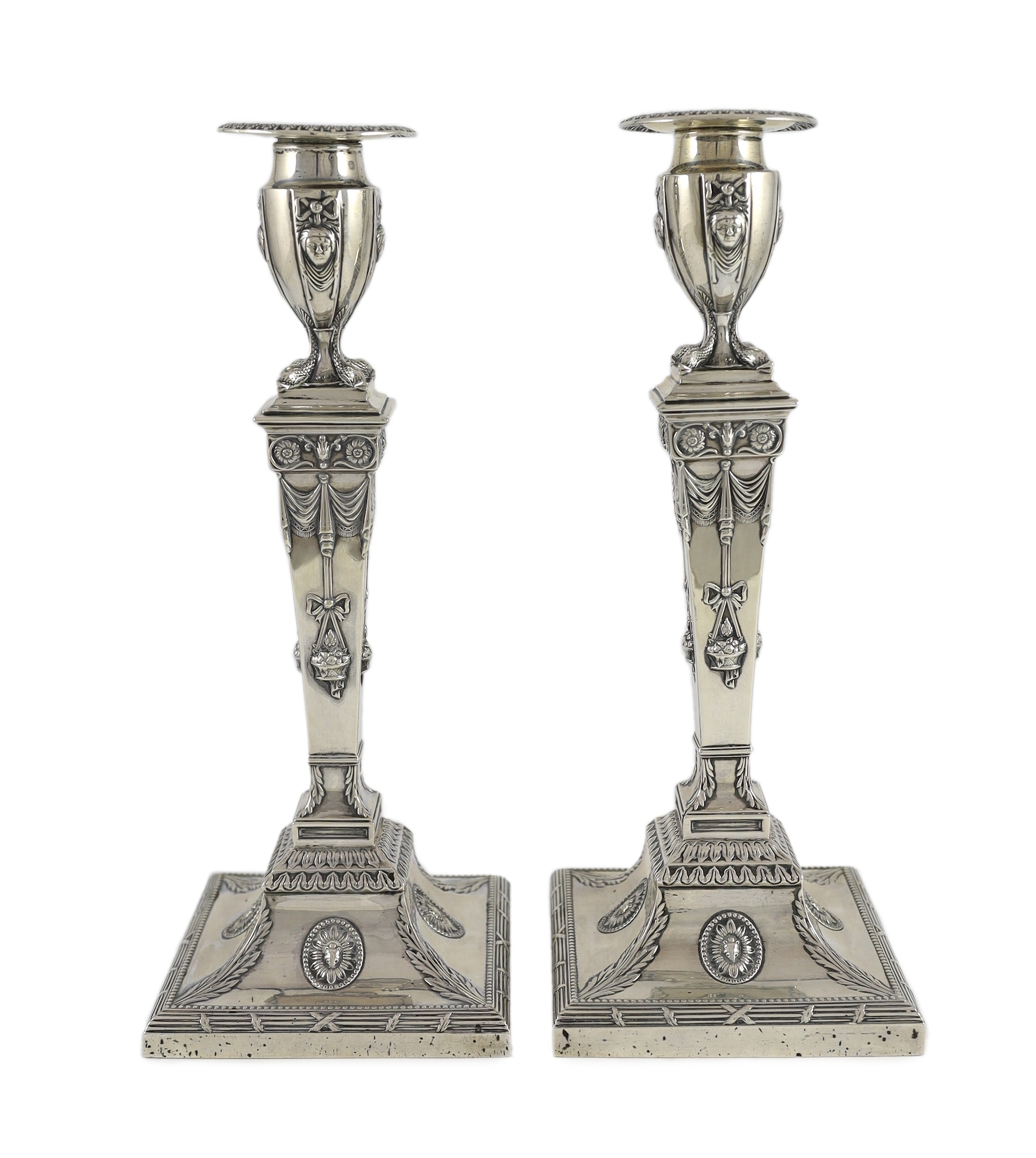 An ornate pair of late Victorian silver candlesticks by Mappin Bros.